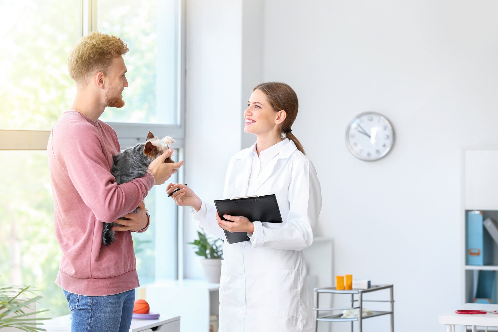 Man with His Dog Visiting Veterinarian in Clinic